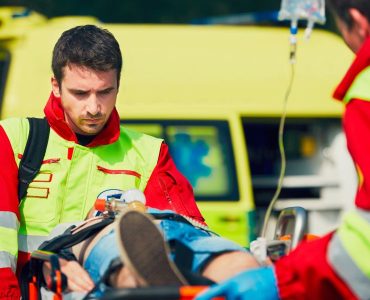 Team of rescuers (paramedic and doctor) preparing the patient after resuscitation for transport to the hospital.